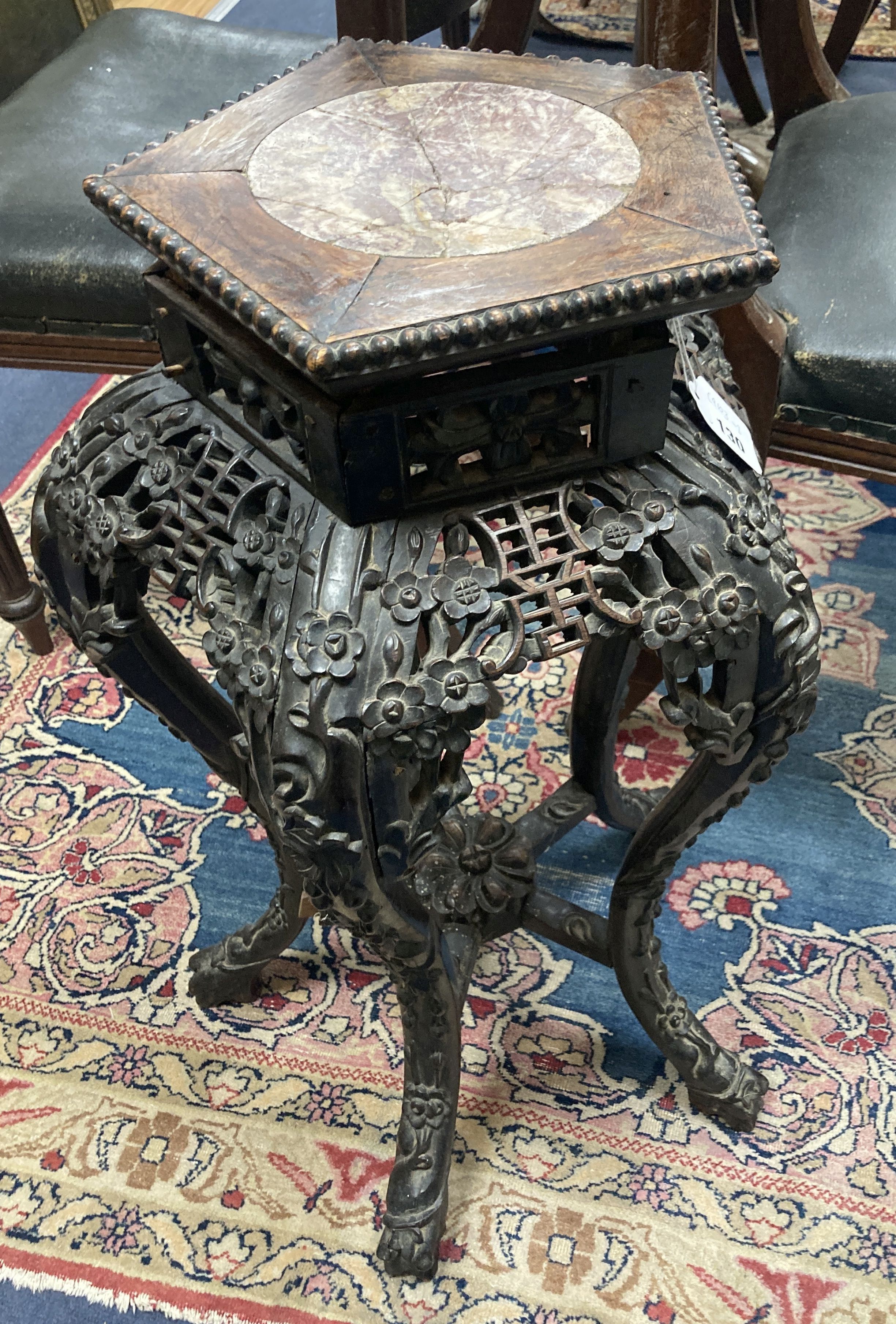 A late 19th/early 20th century Chinese carved jardiniere stand, 65cm. high